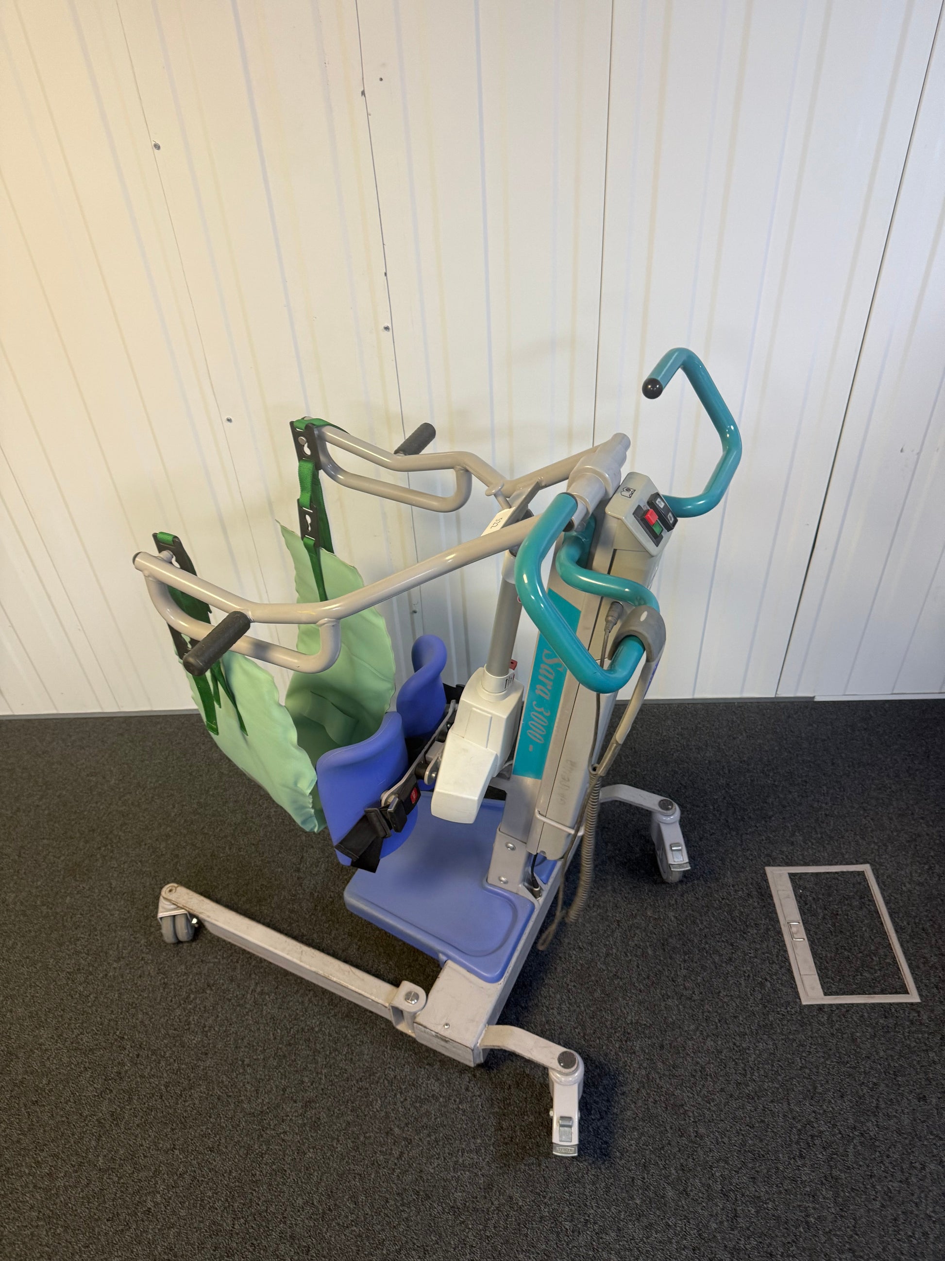 Arjo Sara 3000 hoist charger next to folded unit